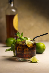 Cuba Libre drink with mint leaves and pieces of lime. Alcoholic drink with rum and cola