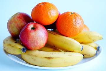 The various fruits, bananas, mandarins, apples.