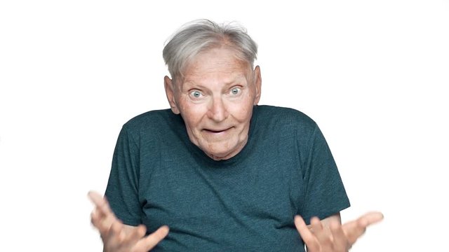 Portrait of irritated mature man 80s having gray hair in casual wear gesturing nervously while screaming question what in puzzlement, isolated over white background slow motion
