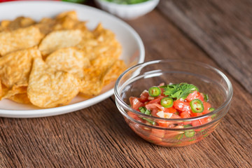 Corn tortilla chips with tomato salsa.