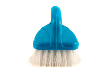 Brush for cleaning household surfaces from dirt on a white background.