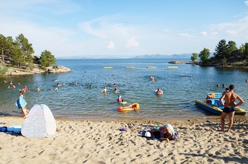 Sandy beach and people floating near the shore! 