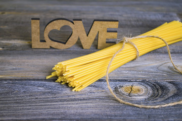 raw spaghetti on an old wooden background love