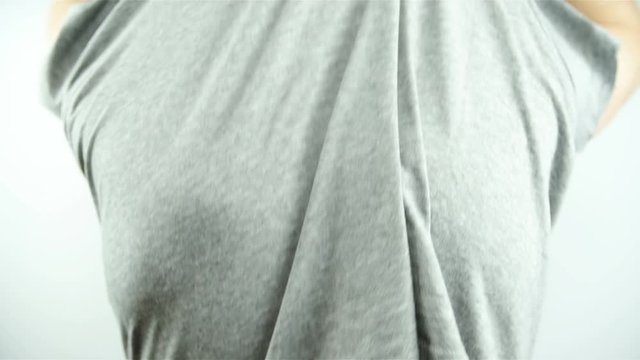 Person undressing shirt showing skin moles 4K