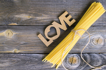 raw spaghetti on an old wooden background love