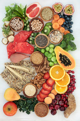 Healthy high fibre dietary food concept with fruit, vegetables, nuts, seeds, cereals, whole grain seeded crackers, whole wheat pasta & herbs. High in antioxidants, anthocyanins, omega 3 and vitamins. 