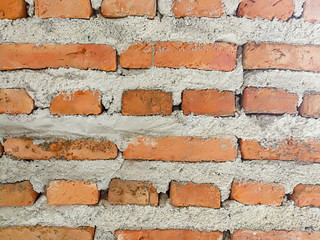 Obraz premium Orange brick wall and grey concrete texture background.