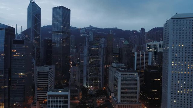AERIAL. Drone footage of Hong Kong city. Camera moving between scyscrapers.