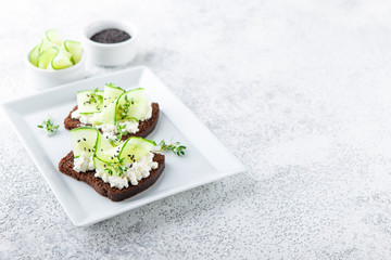 Toasts with ricotta, cucumber and black sesame