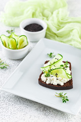 Toasts with ricotta, cucumber and black sesame