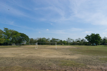 Soccer field and old football goal on the village sports field in summer day., soccer field at urban school. sport concept...