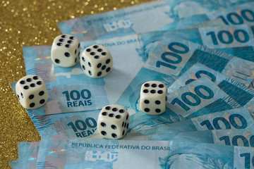Brazilian money, reais and dice for the game / lucky business concept.