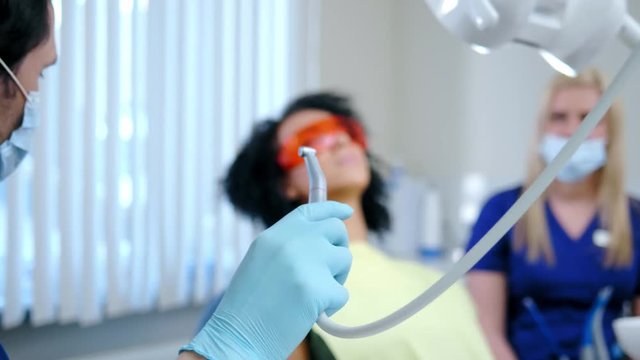 Dentist and his assitant working in private practice.
