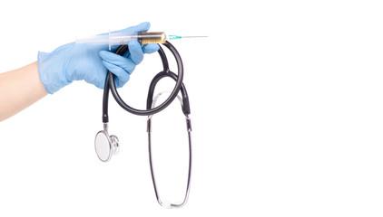 The stethoscope and syringe in hand in medical glove medicine