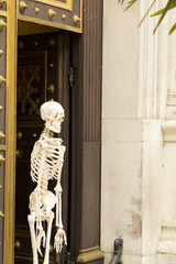 skeleton at the front door of the building