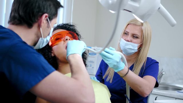 Dentist and his assitant working in private practice.