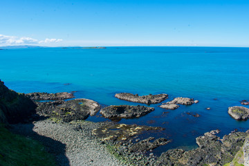 landscape over coast and ocean water during sunny day. horizon over water clear blue sky on background 