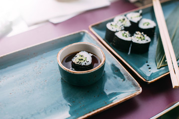 vegetarian sushi on green ceramic dishes.
