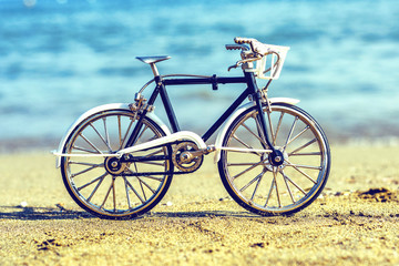 Daylight view to handicraft bicycle souvenir on sand