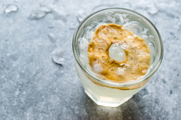 Pear Juice Cocktail with Dried Pear Slice and Crushed Ice.