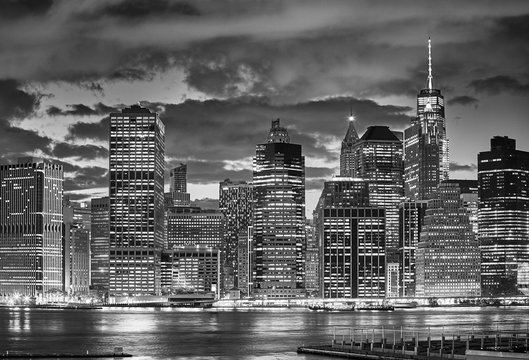 Black and white picture of Manhattan skyline at night, New York City, USA.