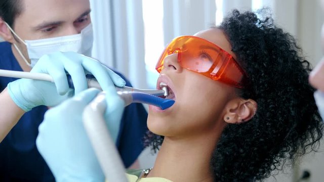 Dentist and his assitant working in private practice.