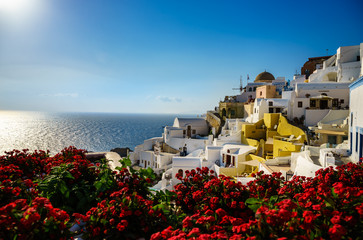 Oia town on Santorini island, Greece. Traditional and famous houses and churches with blue domes over the Caldera, Aegean sea 