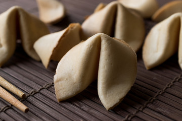 Chinese Fortune Cookies on Bamboo Mat with Chopsticks and Paper