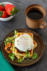 Savory belgian waffles with salad and poached egg