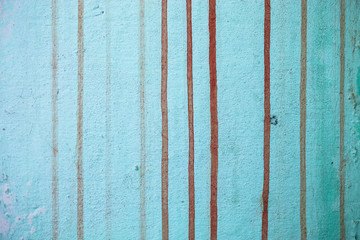 Blue painted concrete wall with red strips