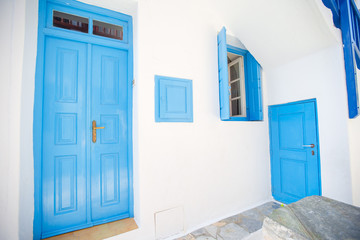 Traditional houses withe blue doors in the narrow streets of Mykonos, Greece.