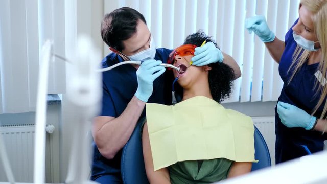 Dentist and his assitant working in private practice.
