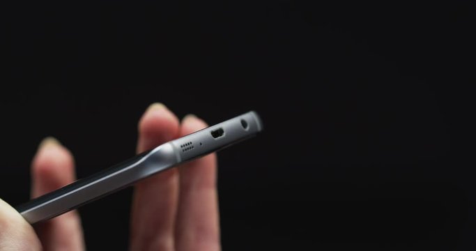 Woman hand unplugging a smartphone 