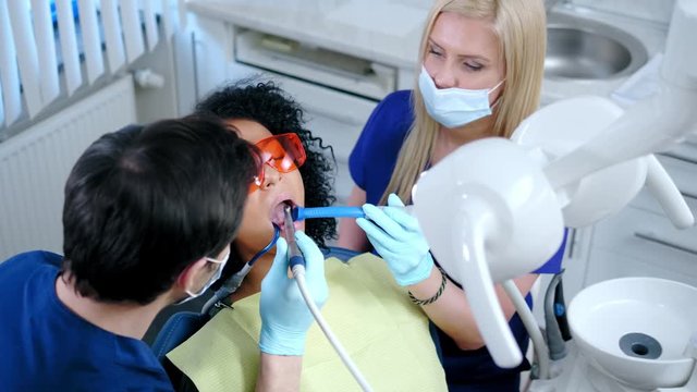 Dentist and his assitant working in private practice.