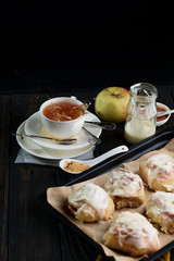 Sweet buns with a block and cinnamon on a dark background