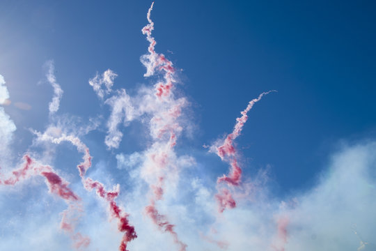 Red smoke in the blue sky.