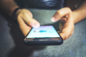 close up of two hands holding a smart phone