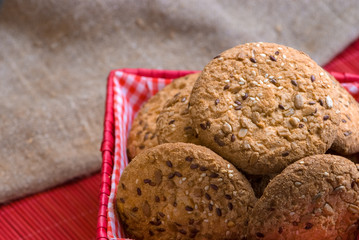 Savory cookies sprinkled with sesame seeds, sunflower on table and burlap background
