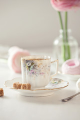 Early morningbreakfast. Vintage cup of coffee and sweets on the table