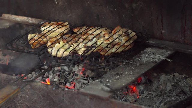 many chicken roast meat pieces on a grill
