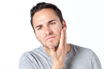 Man in gray T-shirt with toothache on white background