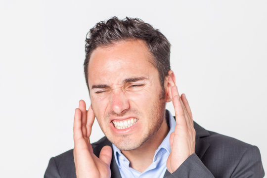 Businessman suffering from ear pain