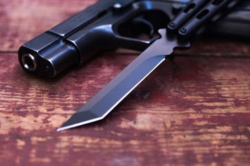 The blade of the knife and the barrel of the gun.