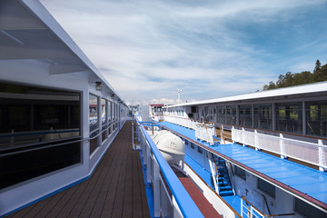 Passenger ships at the pier. Walking decks, lit by the sun.