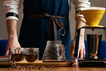 Fototapeta na wymiar Barista making coffee, close-up. Bartender preparing coffee drink