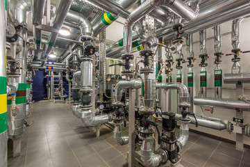Central heating system in the basement of an large building. Pipelines, water pump, valves,...