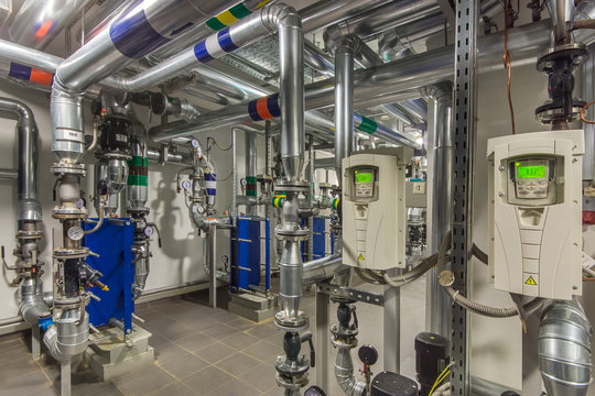 Modern independent heating system in boiler room. Pipelines, water pump, valves, manometers