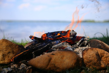 burning bonfire closeup on a background of water