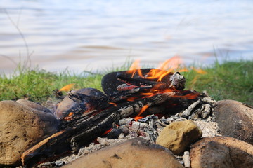 burning bonfire closeup on a background of water