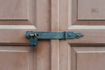 Locked wooden doors with black metal lock